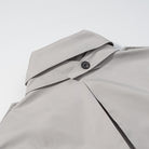 Light gray langry fashion shirt with black buttons in loose long sleeve coat design