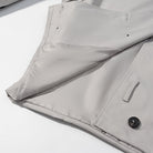 Light gray langry fashion puffer jacket with black buttons and white trim