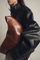 Elegant Langry faux leather bomber jacket with brown clutch bag