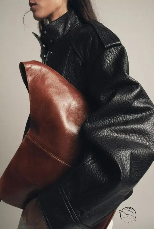 Langry faux leather bomber jacket with brown leather clutch bag and black high collar