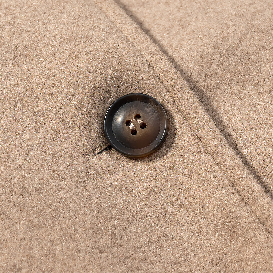 Elegant langry autumn woolen coat with brown four-hole button on beige fabric