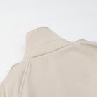 Langry Cozy Belt Trench Coat in beige with button details and pocket flaps