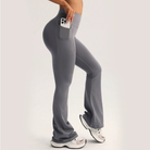 Gray high-waisted flared langry yoga pants with side pocket holding smartphone