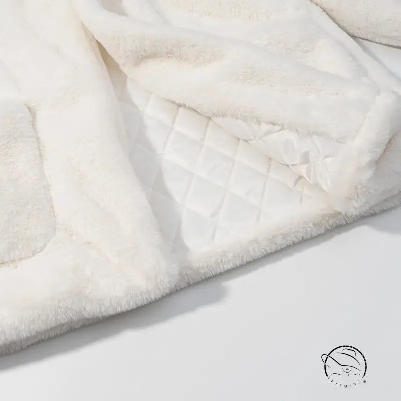 Cream faux fur blanket with quilted diamond stitching and langry fashion trim