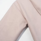 Elegant langry blush-pink wool coat with waist control and lace-up fashion design