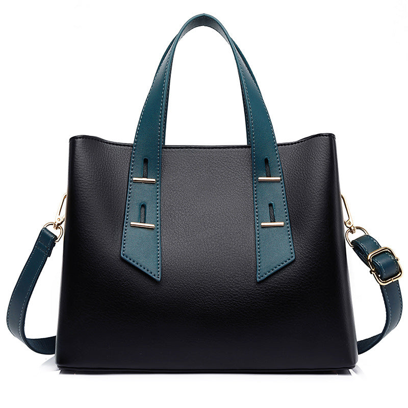High-grade soft leather handbag in black with teal accents and silver hardware