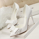 White high heels with decorative bows, perfect blend of elegance and style in fashion clothing
