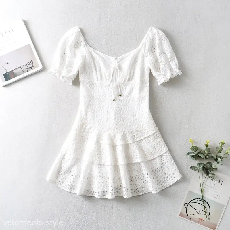Elegant short lace white mini dress on display