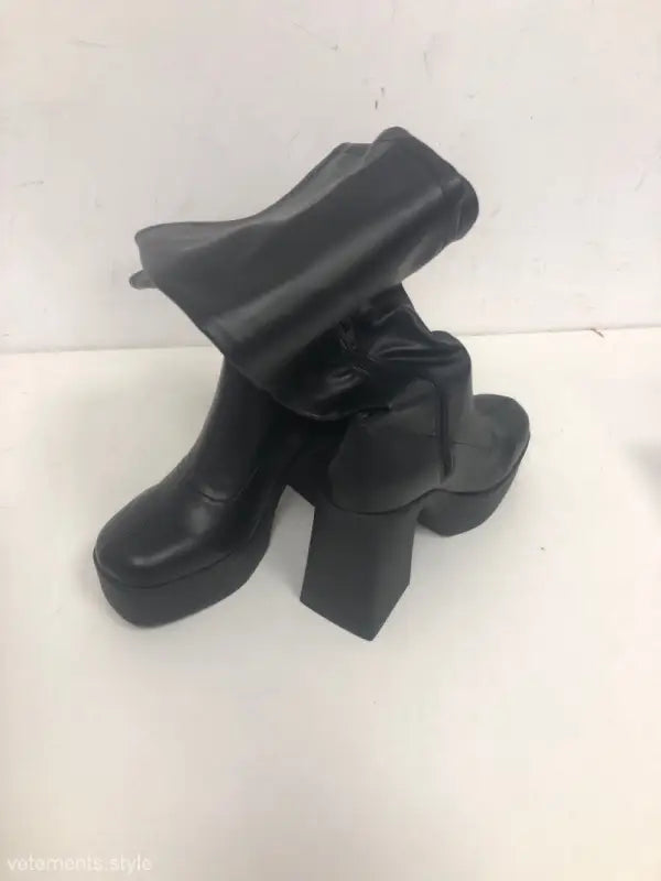 Classic black knee-high boots with chunky heels and platform design for a stylish look
