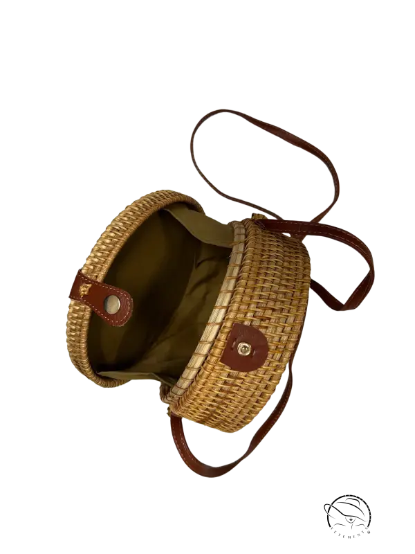 Stylish sustainable handbag with rattan weave, leather straps, tan exterior, olive lining