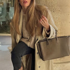 Beige leather tote bag with gold hardware, regular sleeve fashion design