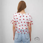 Elegant faux cotton short top with red heart pattern on white t-shirt and light blue jeans