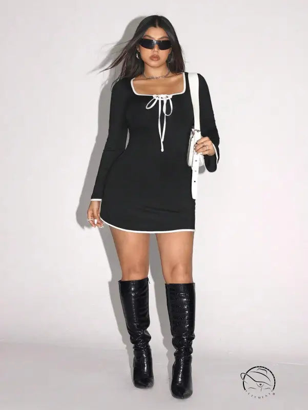 Elegant sweet spicy dress: woman in black and white trim with knee-high boots