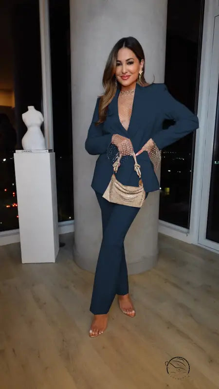 Woman in teal pantsuit from casual professional pants two piece set