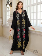 Elegant embroidered Middle East kaftan dress with black floral pattern and gold accents