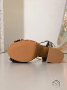 Brown leather leopard print shoes with orange accents and textured soles