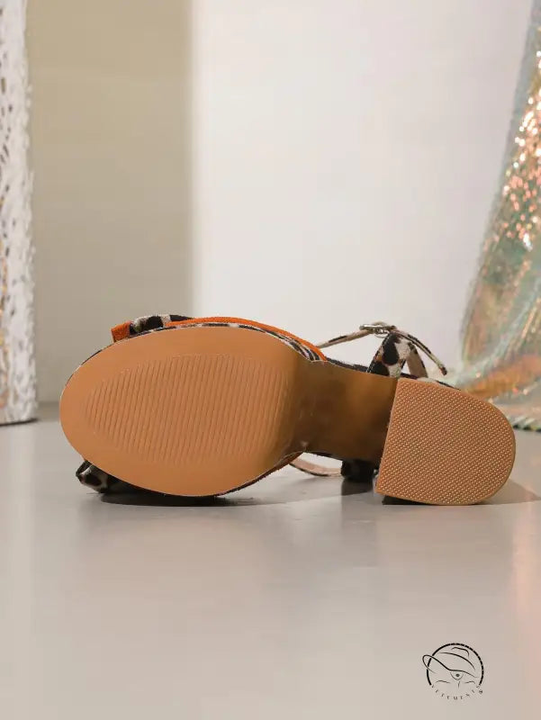 Brown leather leopard print shoes with orange accents and textured soles