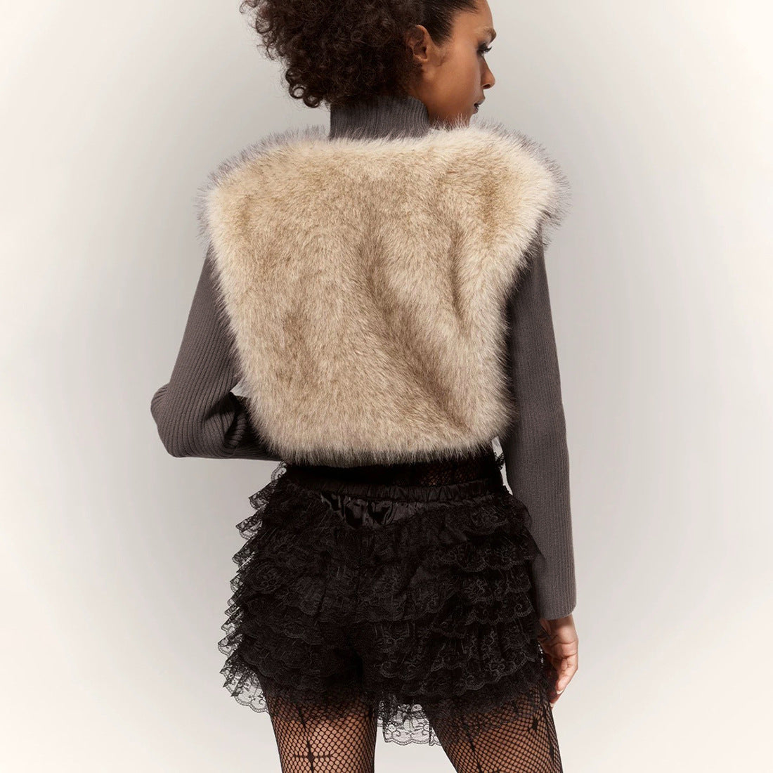 Langry fashion beige faux fur cropped vest with lace skirt and fishnet stockings