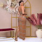 Sheer beaded evening gown showcasing scalloped embellishments and side slit for fashion