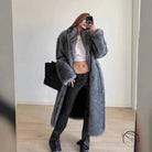 Elegant cozy faux fur coat with long plush gray texture and wide cuffs