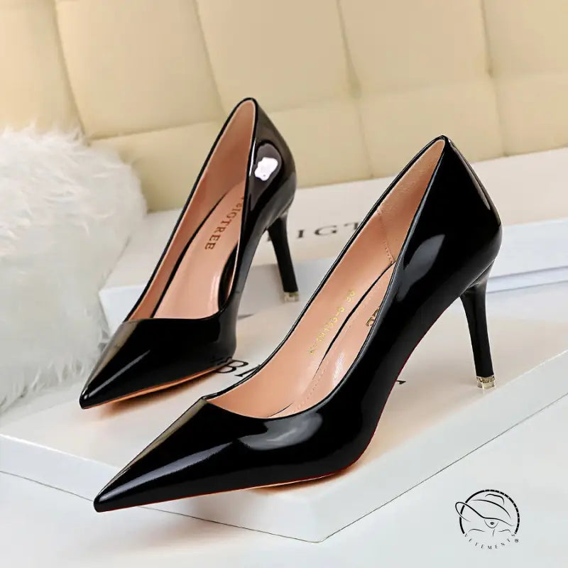 Pair of fashionable black patent leather stiletto heels