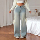 Light-wash high-rise wide leg jeans with cream lace-up side ties