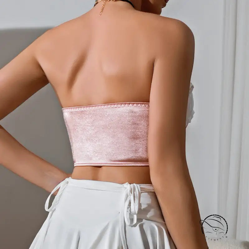 Light pink strapless wooden ear bow tube top with white drawstring mini skirt