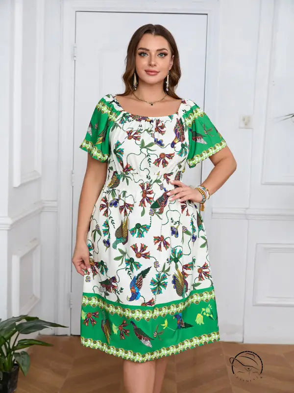 Elegant bohemian dress in white and green floral print with cinched waist