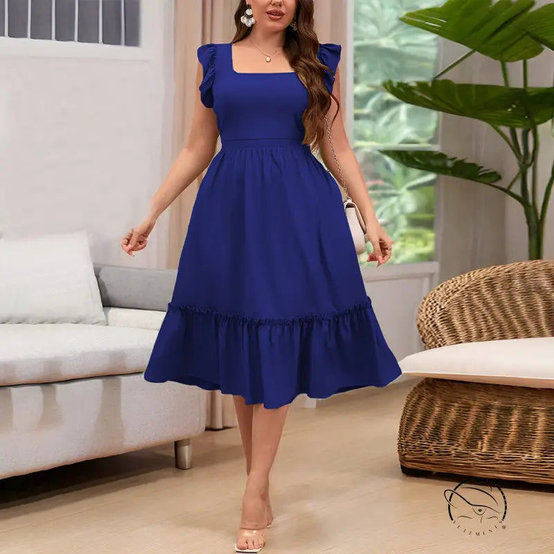 Woman in royal blue vacation casual midi dress with ruffles