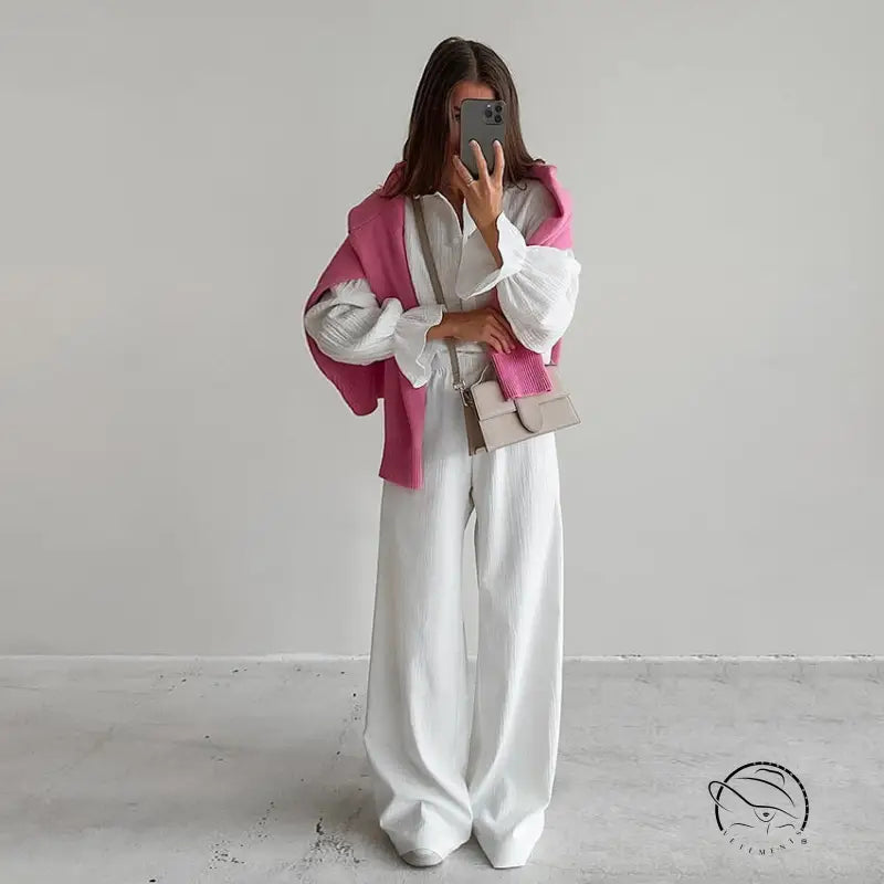Woman in white pure cotton homewear blouse, trousers, pink sweater, bag
