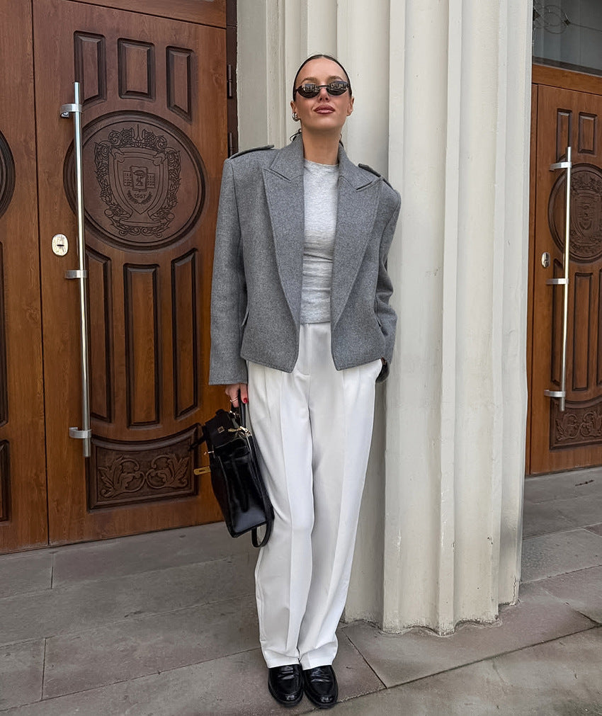 Langry fashion gray textured blazer with white pants and black accessories