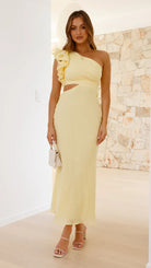 Woman in yellow one-shoulder dress highlighting elegant fashion in ملابس collection