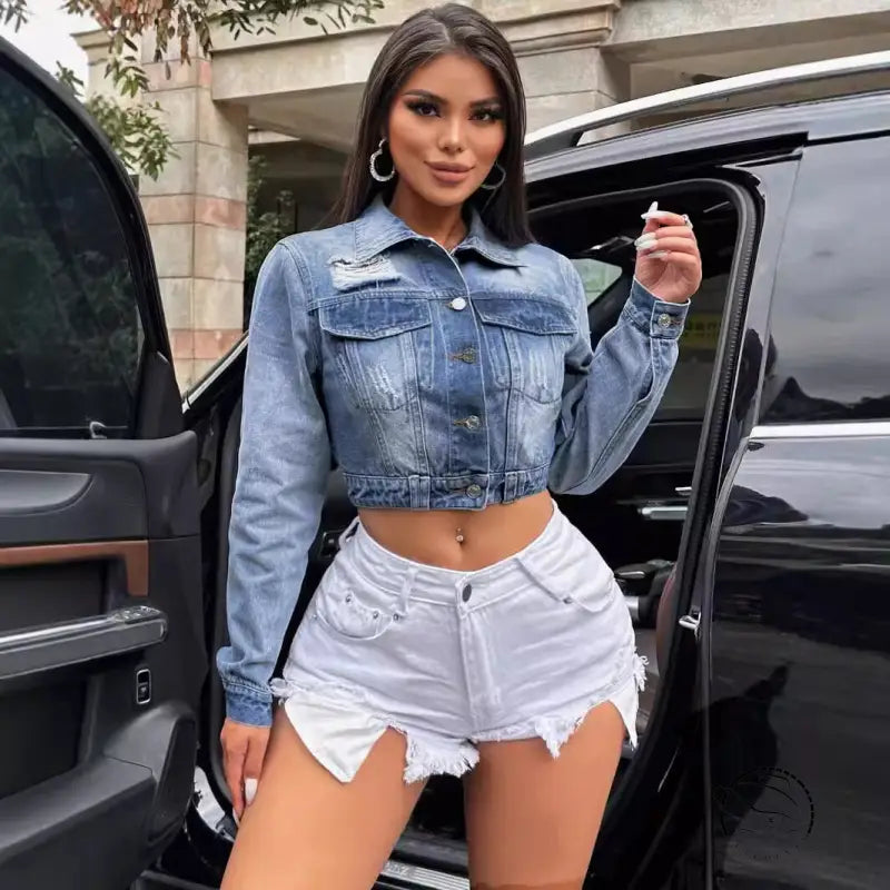 Woman in loose short denim coat with blue jacket and white shorts