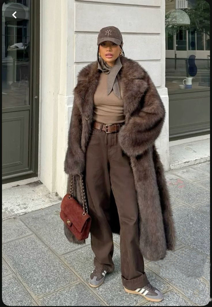 Brown faux fur vintage jacket with belt, cap, and Adidas sneakers