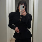 Langry fashion black peplum top with gold buttons and puffed sleeves