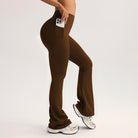 Brown wide-leg high-waist yoga pants in langry fashion with side pocket holding white smartphone