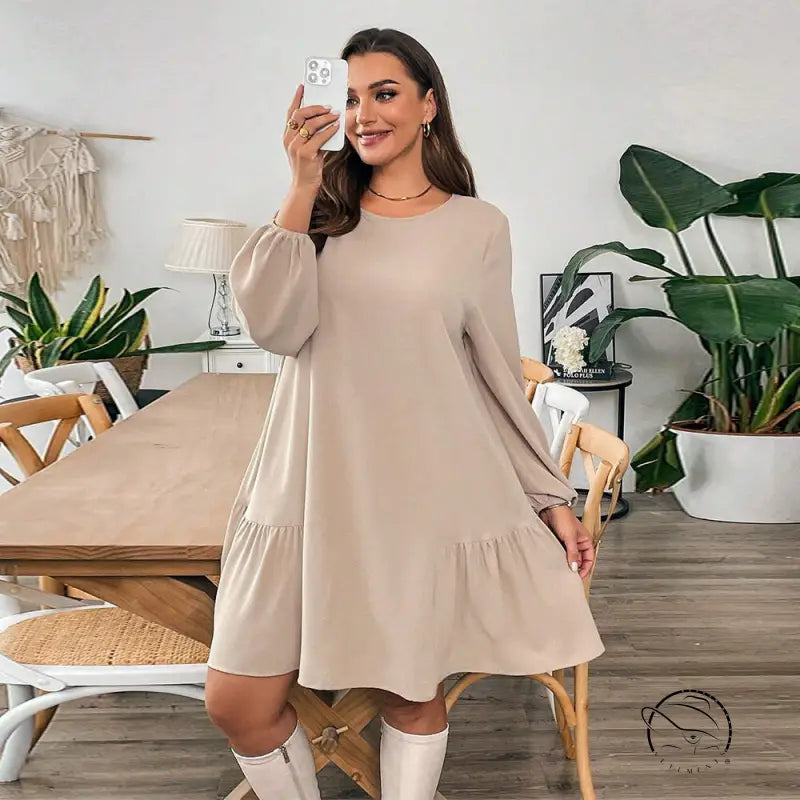 Woman in beige tiered midi dress with white knee-high boots, langry fashion