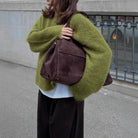 Olive green fuzzy wool alpaca sweater with brown leather shoulder bag