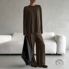 Woman in round neck loose long-sleeve brown pajama suit with wide-leg pants and tote bag