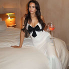 Elegant slim fit backless strap dress in white satin with black bow and lace trim from Langry fashion