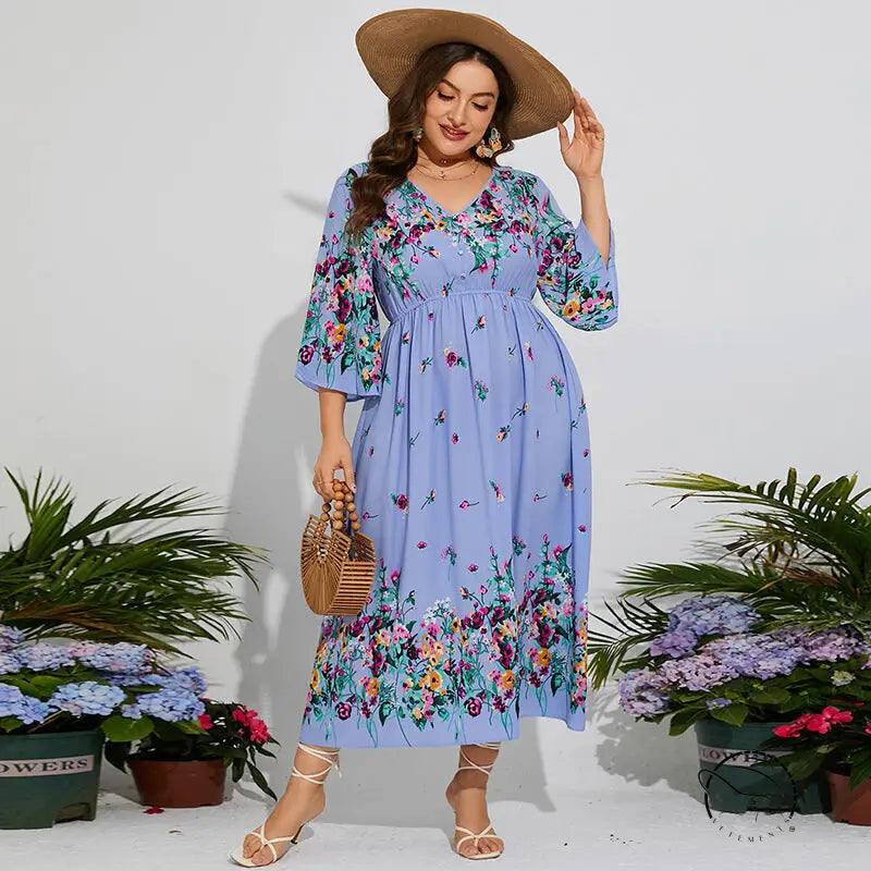 Woman in floral chiffon spring dress with elastic waist, V-neck, ruffles, hat, bag, heels