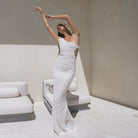 Elegant form-fitting white beaded wedding gown with strapless design for fashion enthusiasts