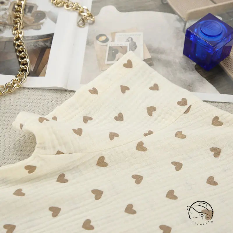 Cream-colored cotton linen fabric with brown heart patterns on summer slit shorts set