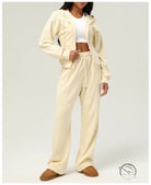 Woman in cream-colored lounge set wearing casual cardigan sweater