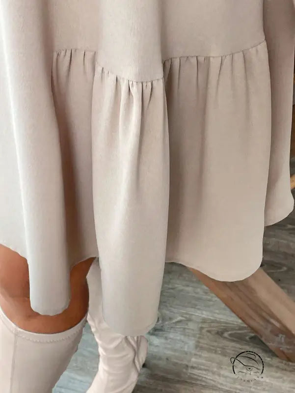 Beige tiered midi dress with long sleeves and ruffled hem for winter fashion