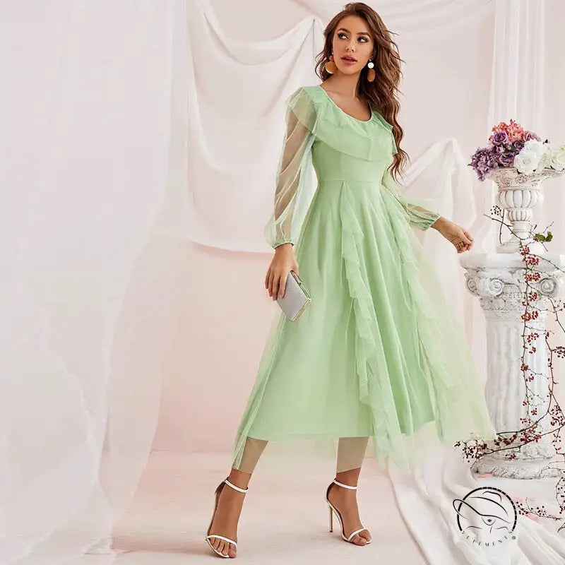 Gorgeous high waist voile A-line dress in flowing mint green with sheer long sleeves and ruffled skirt