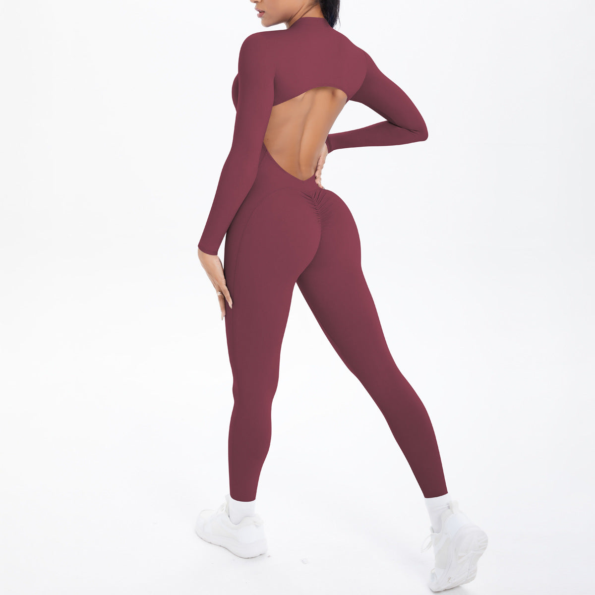 Maroon long sleeve yoga jumpsuit with back cutout and high-waisted leggings