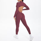 Maroon long sleeve yoga jumpsuit with back cutout and high-waisted leggings