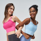 Two women in CUTE PLEATED MESH YOGA VESTs, one in Glacier Blue, one in Cherry Blossom Powder