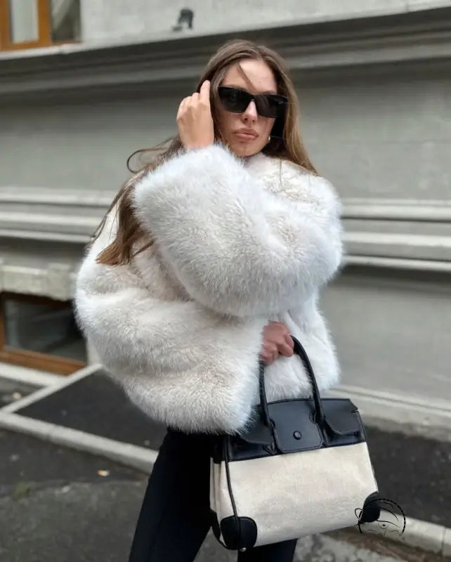 Cozy short faux fur coat with white fur, black trim, structured shoulders